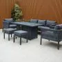 Aurora lounge garden furniture set featuring a modern grey rope design with comfortable cushions and fire pit table. Elegantly arranged in a garden setting with sleek cladding in the background