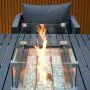 Aurora lounge garden furniture set featuring a modern grey rope design with comfortable cushions and fire pit table. Elegantly arranged in a garden setting with sleek cladding in the background