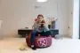 Front View of the Girl Sitting on the West Ham United F.C. Gaming Bean bag Chair in the Living Room 