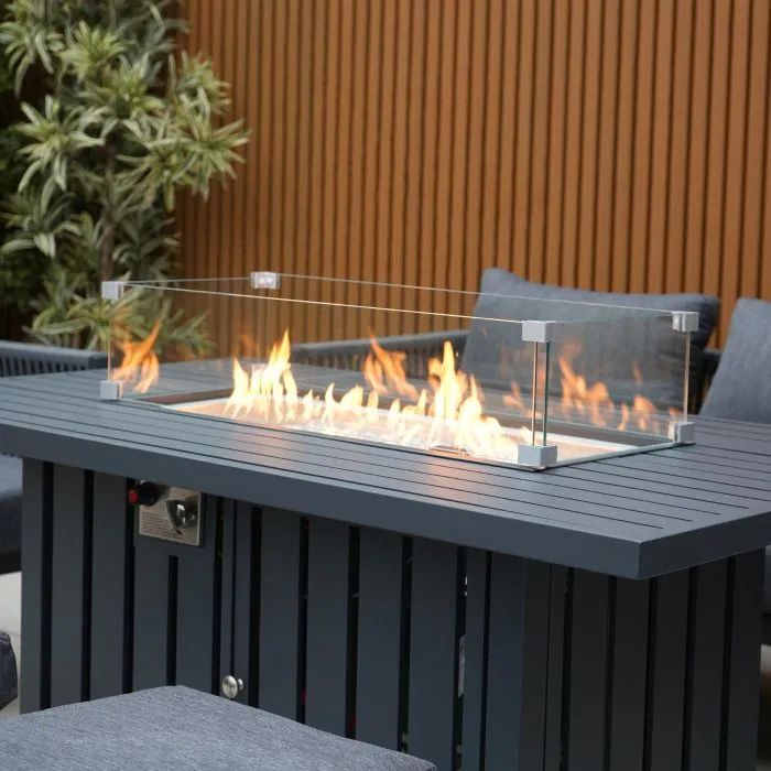 Aurora lounge garden furniture set featuring a modern grey rope design with comfortable cushions and fire pit table. Elegantly arranged in a garden setting with sleek cladding in the background