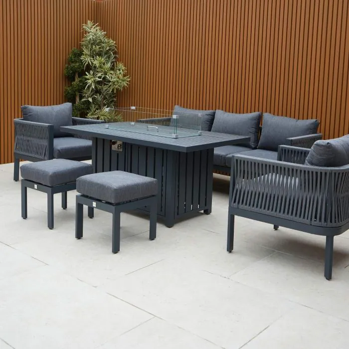 Aurora lounge garden furniture set featuring a modern grey rope design with comfortable cushions and fire pit table. Elegantly arranged in a garden setting with sleek cladding in the background