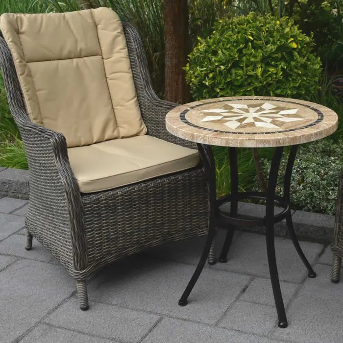 Close up of stone top bistro table with compass design