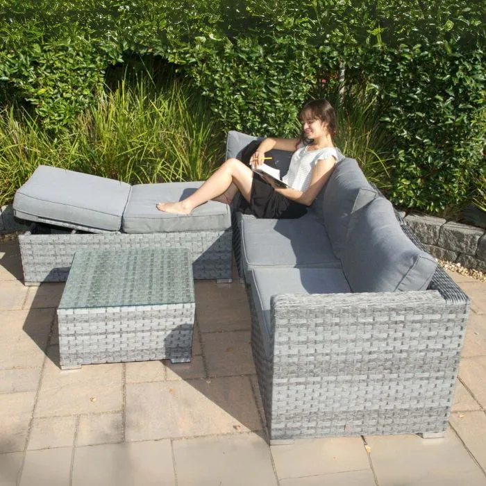 Grey rattan corner set with adjustable sun lounger function, rust-resistant frame, and plush cushions for outdoor relaxation