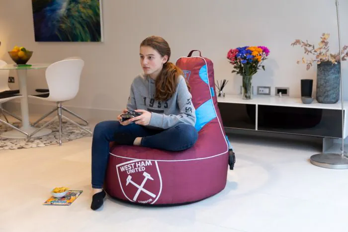 Girl Sitting on the West Ham United F.C. Gaming Bean bag Chair In the Living Room