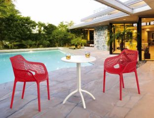 2 Red Air XL Chairs and White Octopus Table Set in the Garden by the Pool 