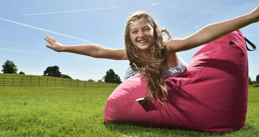Girl lying across chair beanbag