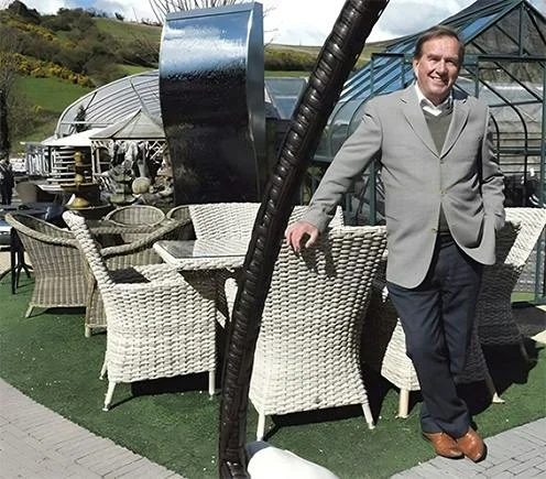 Pat kelly standing beside furniture set