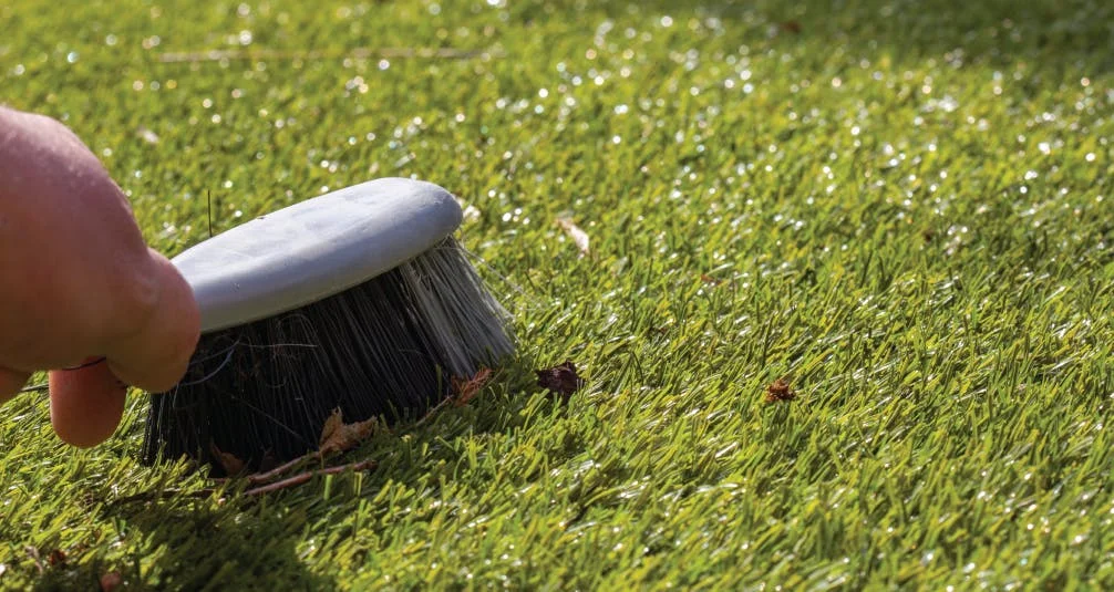 Brushing Artificial Grass of Leaves